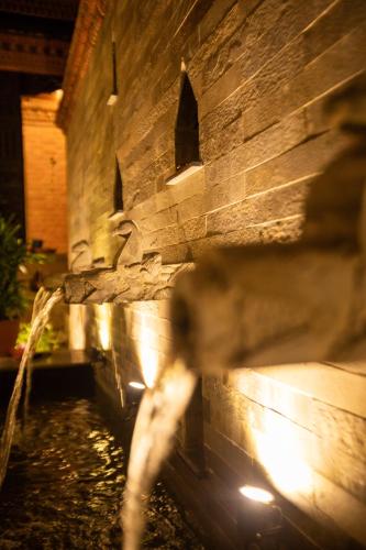 a blurry picture of a stone building with lights at Nag Pukhu Guest House in Bhaktapur