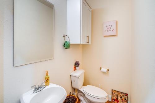a bathroom with a sink and a toilet and a mirror at Walk to Historic Dtwn McKinney Family Retreat in McKinney