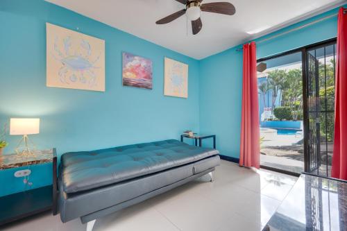 a blue bedroom with a bed and a ceiling fan at Canela Costarican Dreams in Coco