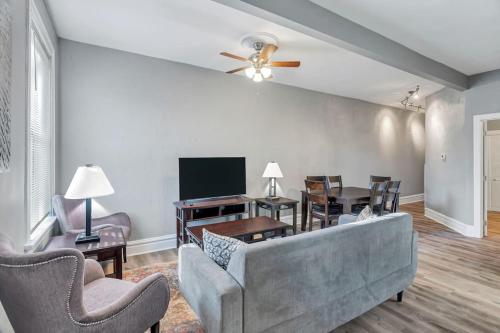 a living room with a couch and a table with chairs at Beautiful Rehabbed Unit in Shaw Community - 4226b in Tower Grove