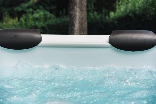 a car with two black handles on top of water at Villa San Giusto - Pool&Relax in Montemassi