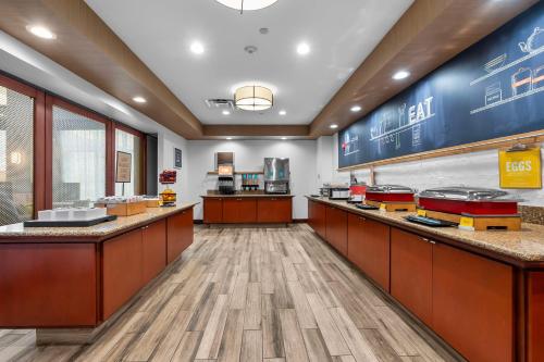 a fast food restaurant with a counter with food at Hampton Inn & Suites - Saint Louis South Interstate 55 in Saint Louis