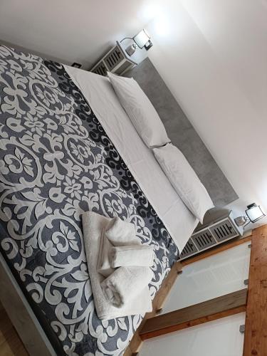 a bed with black and white sheets and pillows at Maison Chic in Ercolano
