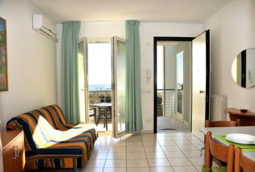 a living room with a couch and a balcony at Isola di Pasqua in Caorle