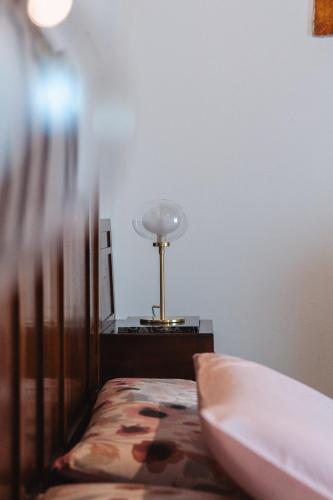 a bedroom with a bed and a lamp on a table at Villa San Giusto - Pool&Relax in Montemassi