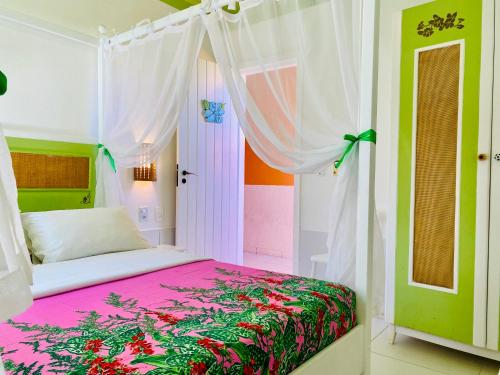 a bedroom with a bed with a canopy at Villa Baobá Pousada & Spa in Búzios