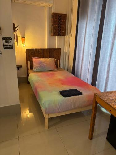 a bedroom with a bed with a colorful blanket at La Locanda in Bangkok