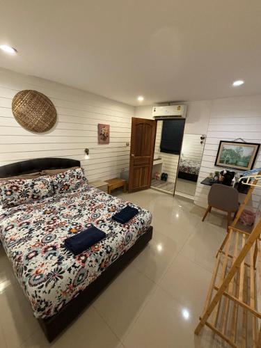 a bedroom with a bed and a staircase in it at La Locanda in Bangkok