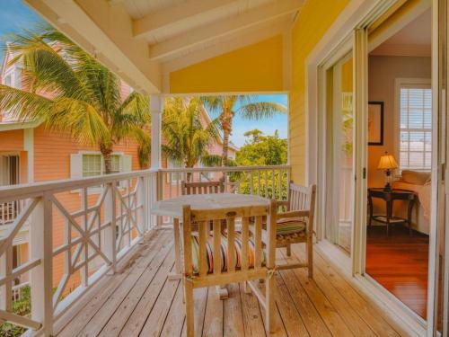 a porch with a wooden table and chairs at Valentines Resort & Marina in Harbour Island