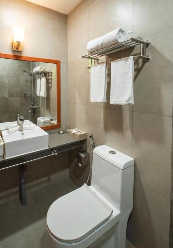 a bathroom with a white toilet and a sink at Araamu Hotels Maldives at Dhiffushi in Dhiffushi