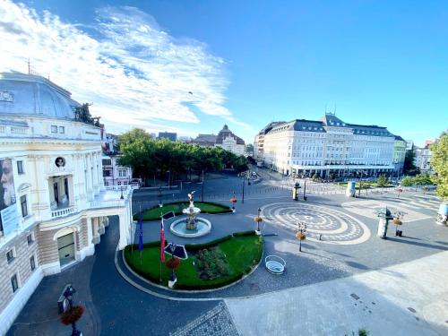 a view of a city with a fountain and buildings at Modern Apartment in Historic City Center Old Town Bratislava in Bratislava