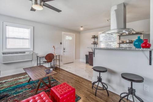 a living room with a table and chairs and a kitchen at Near OU Medical Bricktown an Artist Apartment in Oklahoma City