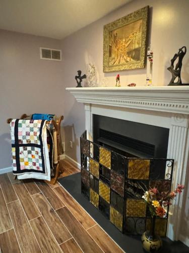 a living room with a fireplace with a mantle at Fenton Oasis in Fenton