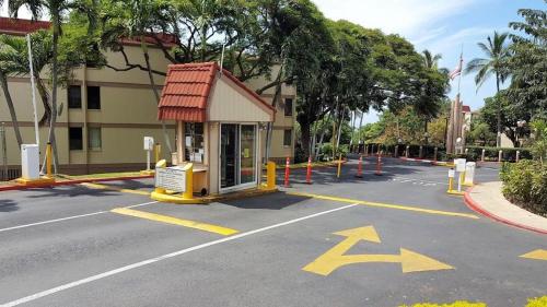 an empty parking lot with a building and a street at Valley Vibes and Beach Bliss Condo for Family Nomads in Waianae