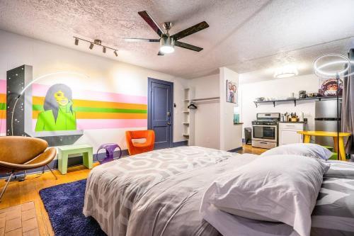 a bedroom with a bed and a colorful wall at Mural studio-near Plaza District in Oklahoma City