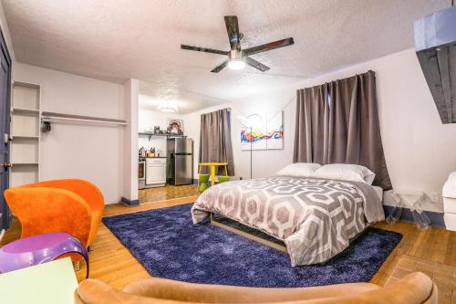 a bedroom with a bed and a blue rug at Mural studio-near Plaza District in Oklahoma City