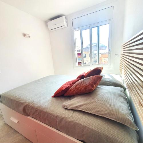 a bedroom with a bed with two pillows on it at Gran Reserva Resort in Empuriabrava