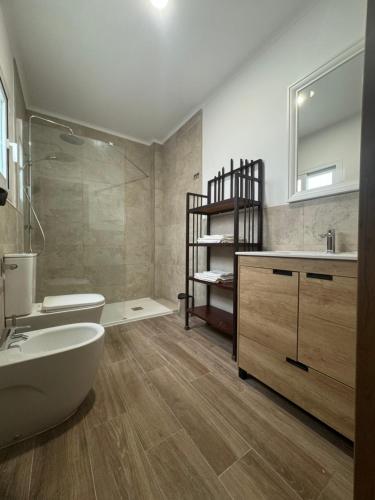 a bathroom with a tub and a sink and a toilet at Casa de la Paz in Estepona