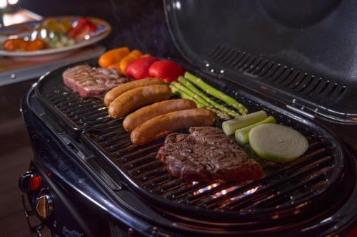 a grill with meat and vegetables on it at 1日1組限定1棟貸し別荘 RivageBlue in Yawata