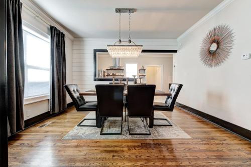 a dining room with a table and chairs at Howes Capitol I - Sleek & stylish walk to OU Med in Oklahoma City