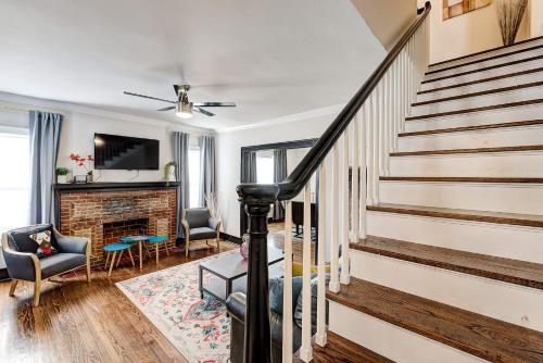 a living room with stairs and a fireplace at Howes Capitol I - Sleek & stylish walk to OU Med in Oklahoma City