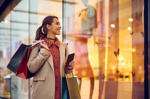 a woman standing in front of a store looking at her cell phone at Candlewood Suites Chattanooga Hamilton Place by IHG in Chattanooga