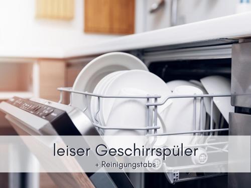 a dishwasher with dishes in it with a dish washer at Komfort FeWo l Moselstay l maximal 4 Personen und Baby I Brauneberg Mosel I WIFI I in Brauneberg