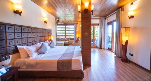 a bedroom with a large bed in a room at Araamu Hotels Maldives at Dhiffushi in Dhiffushi