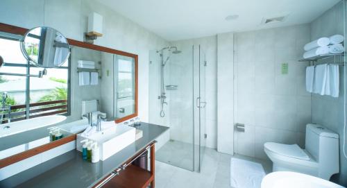 a bathroom with a toilet and a sink and a shower at Araamu Hotels Maldives at Dhiffushi in Dhiffushi