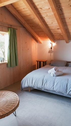 a woman laying on a bed in a room at Haixpia, Les Chambres d'Hôtes in Hasparren