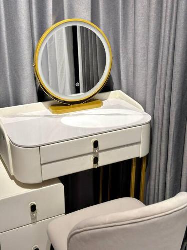 a bathroom with a mirror on top of a sink at URBAN Suites Modern Pinky 6pax 3queen 3Bedroom 2Bathroom 2Carpark with Infinity Pool in Jelutong
