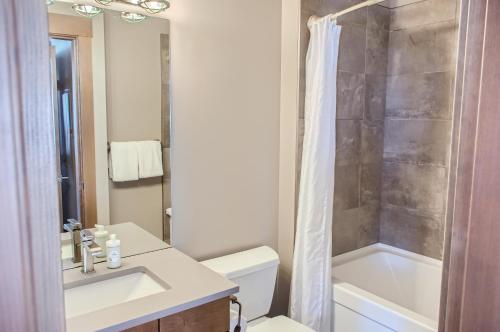 a bathroom with a sink and a toilet and a shower at Stonegate Resort Unit B208 in Big White