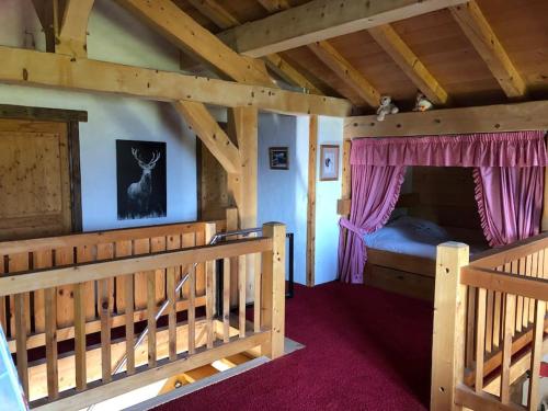 a bedroom with a bed in a wooden cabin at Chalet les Champerons - Entre Lacs et Montagne in Marthod