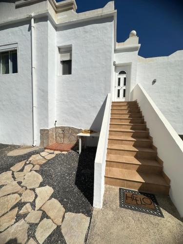 a white building with a staircase in front of it at Casa Adriana in Costa Calma