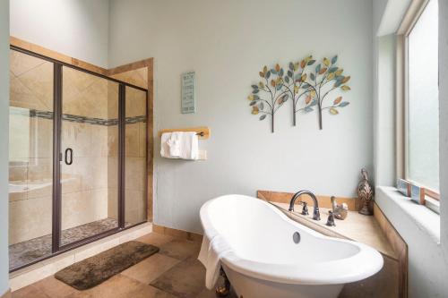 a bathroom with a shower and a white sink at Worth the Wake in Branson