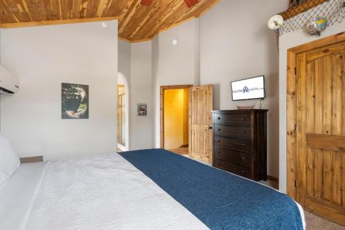 a bedroom with a large bed and a wooden dresser at Worth the Wake in Branson