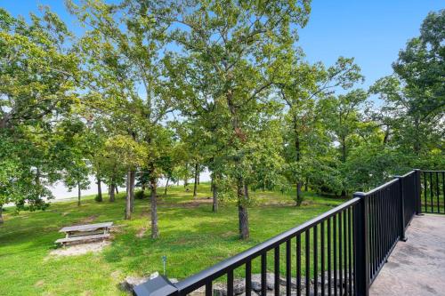a view of a park with a bench and trees at Worth the Wake in Branson