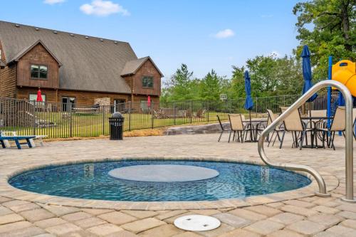 a small pool with a slide in a playground at Worth the Wake in Branson