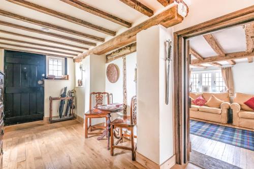 a living room with a table and chairs and a couch at Huge Cottage for Sophisticated Hen Party and Large Groups in Hurst