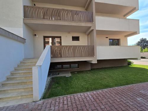 a house with a staircase in front of it at Apartament zona ISU Bistrita in Bistriţa