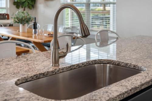 a kitchen sink in a kitchen with a table at Breathtaking Lake Views-Dog Friendly-$400 of Free Tickets-High End Decor in Branson