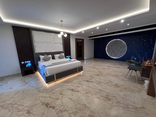 a bedroom with a bed and a moon mural at Silver Stone Park Resort, Kovilpatti in Kovilpatti