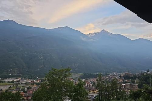 a view of a city with mountains in the background at Il casolare del Druido in Châtillon