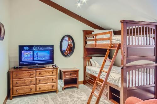 a bedroom with a bunk bed and a television at Stonegate Resort Unit A401 in Big White