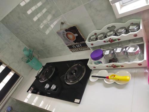 an overhead view of a kitchen with a stove top oven at IMPIAN Kasih in Cukai