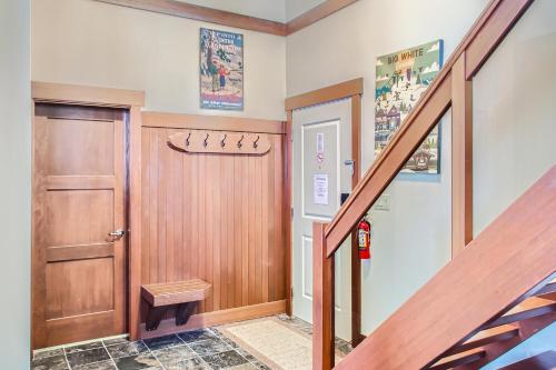 a hallway with a wooden door and a staircase at Stonegate Resort Unit A401 in Big White