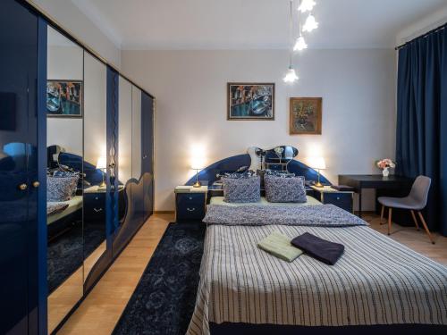 a bedroom with two beds and a desk in it at Alunana Premium & Fireplace apartment in Art Nouveau district, 63 sqm, 1870s, Self check-in in Rīga