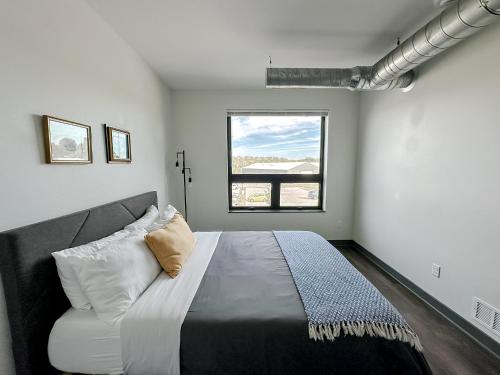 a bedroom with a large bed and a window at Sleepover 1BD 1BA Des Moines Apartments in Des Moines