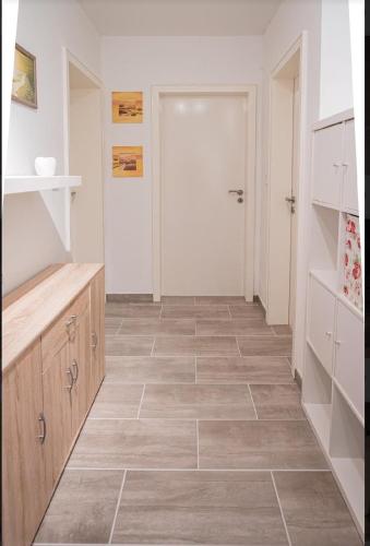 a bathroom with a tiled floor and a closet at Wohnung in Edermünde in Holzhausen am Hahn