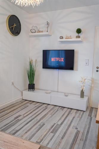 a living room with a tv on a white wall at Wohnung in Edermünde in Holzhausen am Hahn